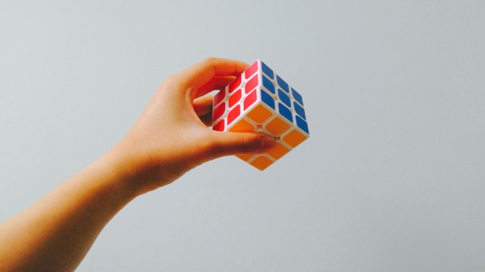 hand-holding-complete-rubik's-cube